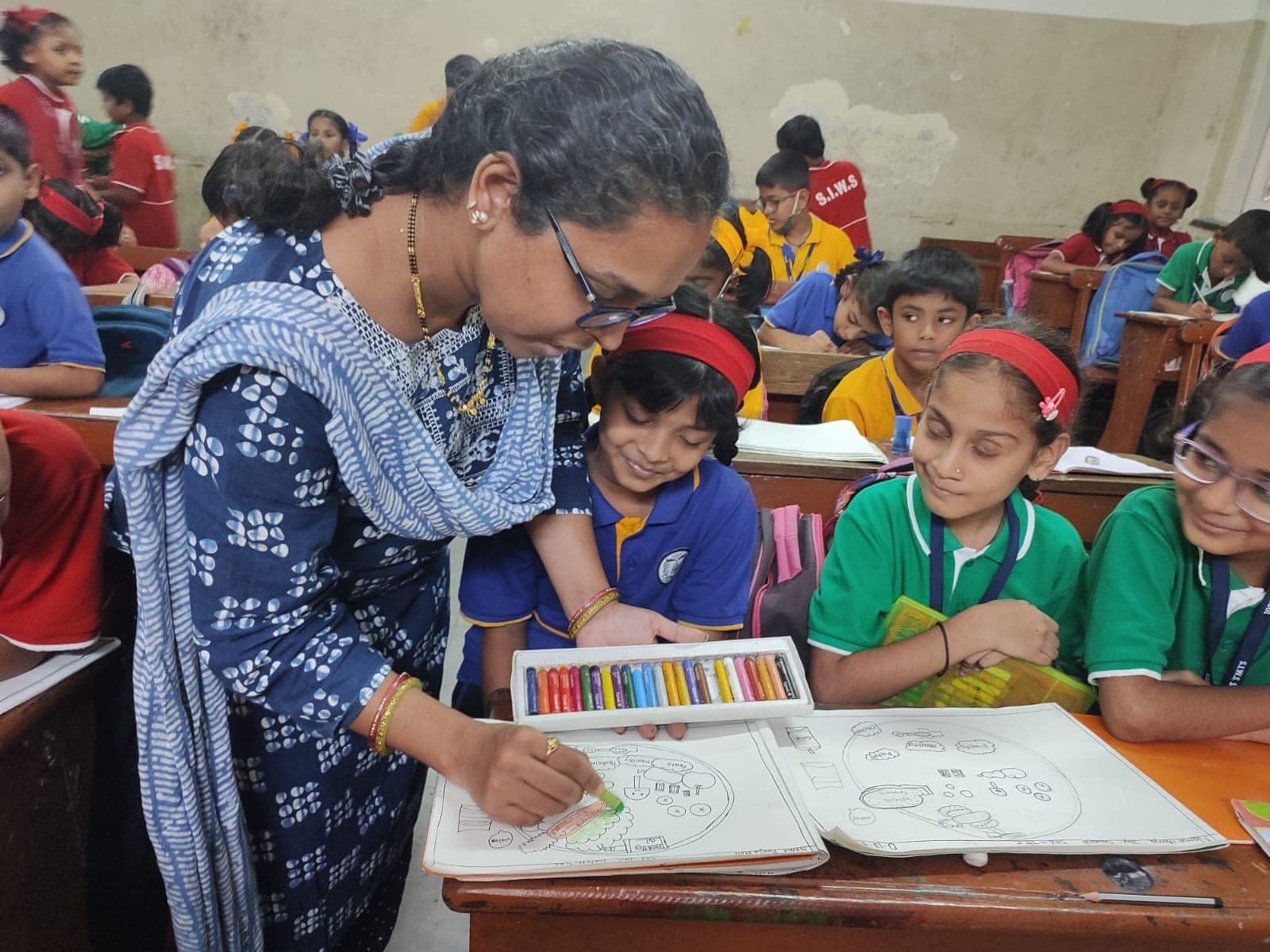 A teacher working with a pupil one to one.