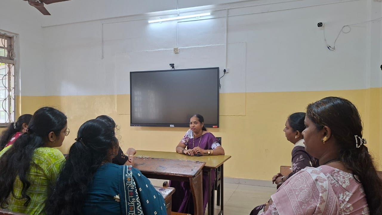 A Primary teacher standing with her class in the classroom.